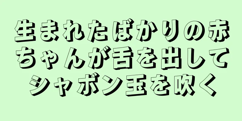 生まれたばかりの赤ちゃんが舌を出してシャボン玉を吹く